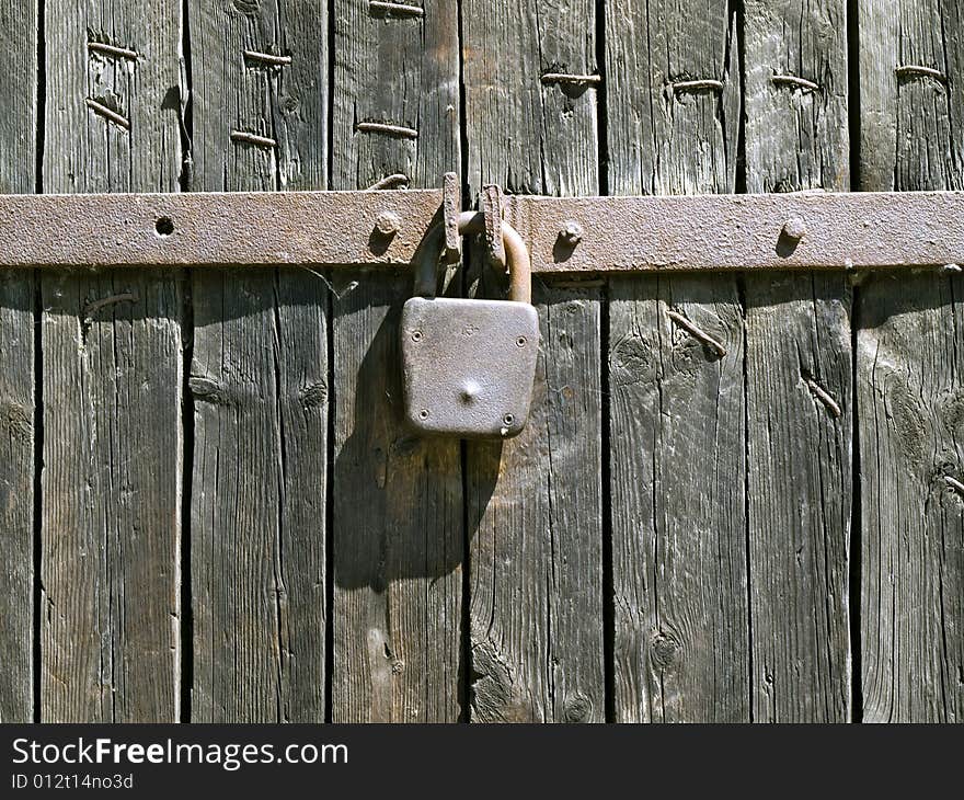 Padlock on the wood door background. Padlock on the wood door background.