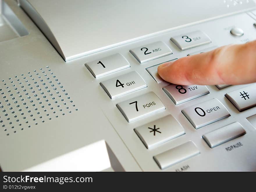 Finger with grey telephone keypad