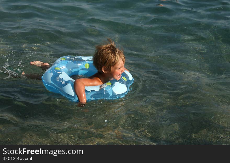 Girl floats on a lifebuoy ring