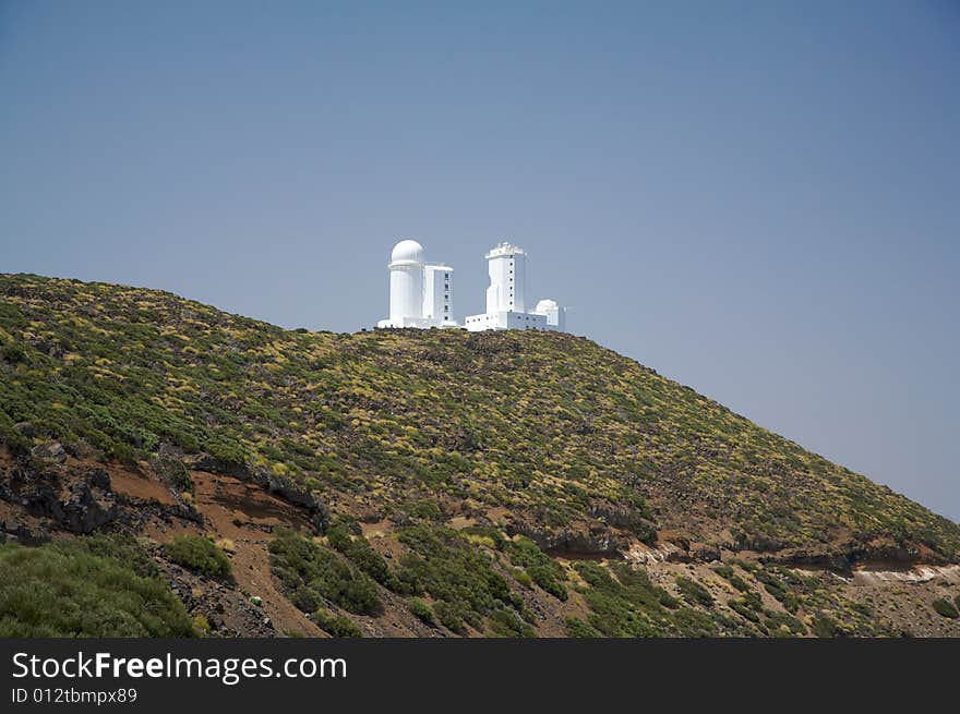 Astrophysic white buildings on a green mountain. Astrophysic white buildings on a green mountain