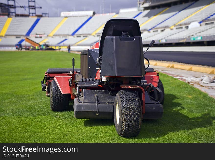 Old lawnmower in a great football field