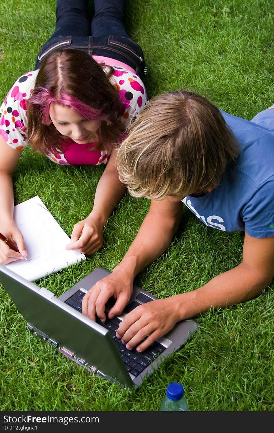 Students studying in a park in the summertime. Students studying in a park in the summertime