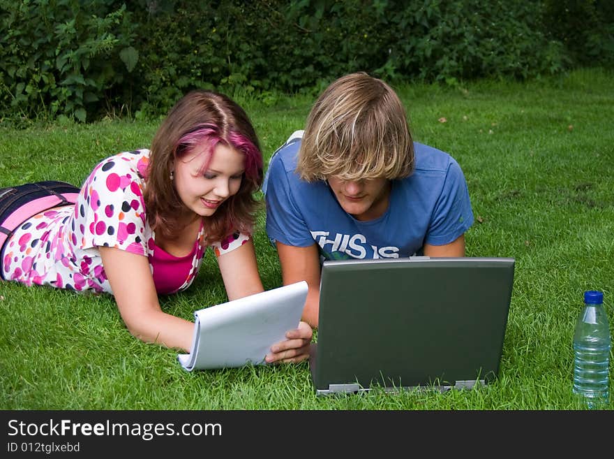 Students studying in a park in the summertime. Students studying in a park in the summertime