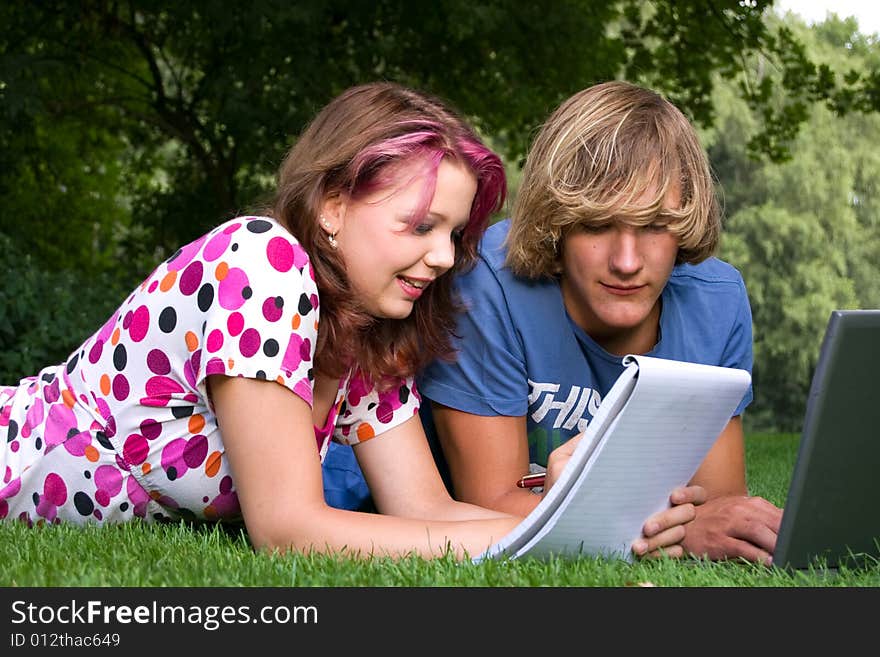 Students studying in a park in the summertime. Students studying in a park in the summertime