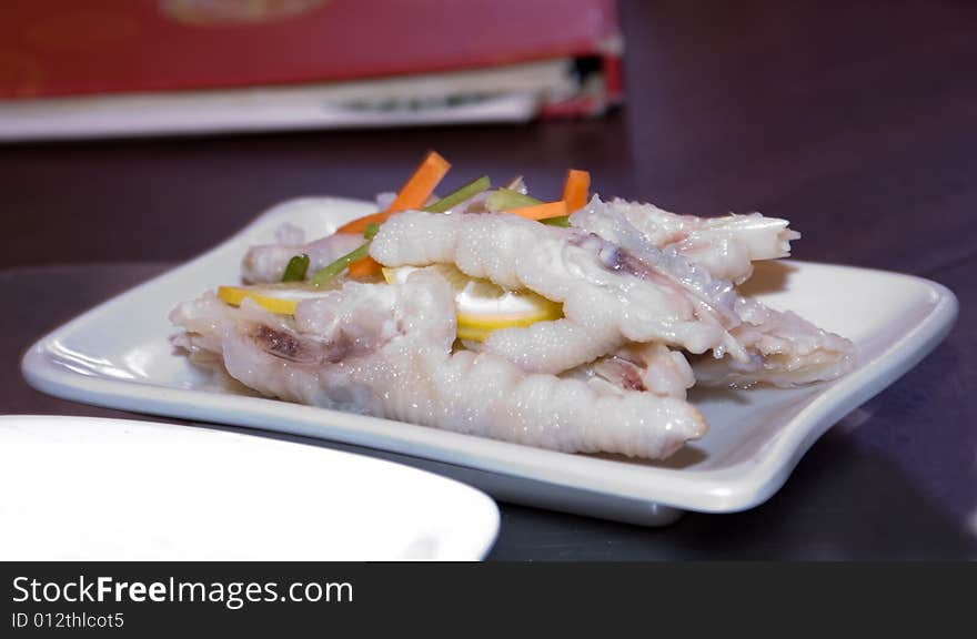 Delicious chinese cuisine - Gold chicken feet with chili in white plate. Delicious chinese cuisine - Gold chicken feet with chili in white plate