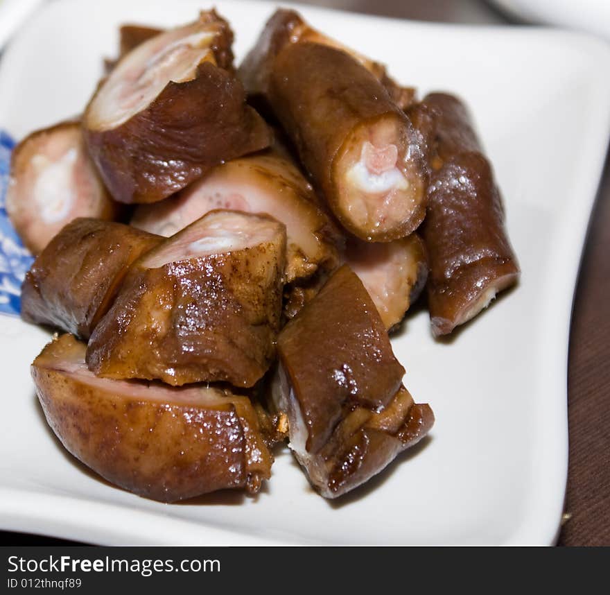 Delicious chinese cuisine - fried pig tail in white plate