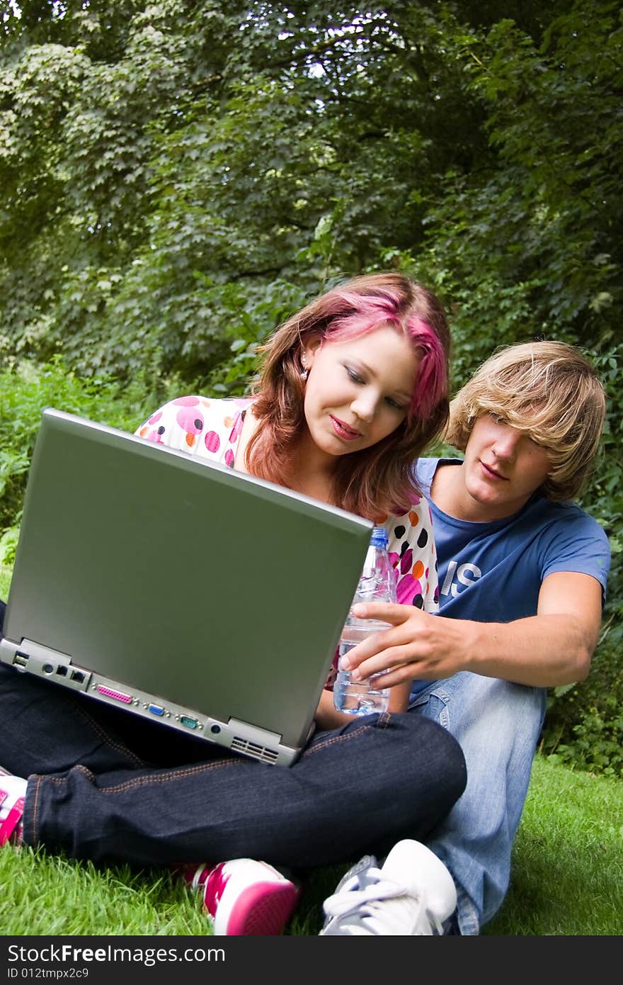 Students studying in a park in the summertime. Students studying in a park in the summertime