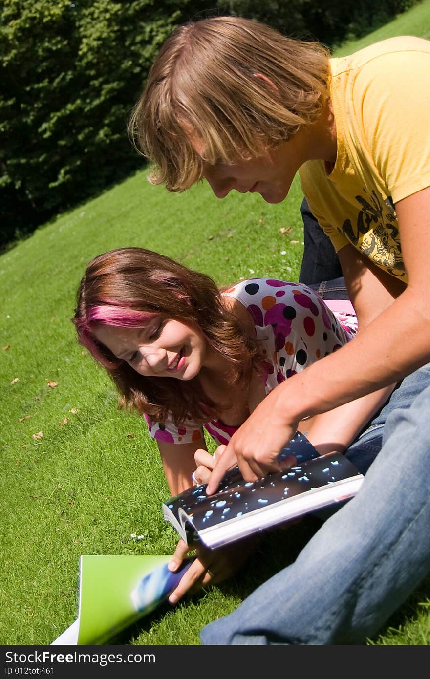 Students studying in a park in the summertime. Students studying in a park in the summertime