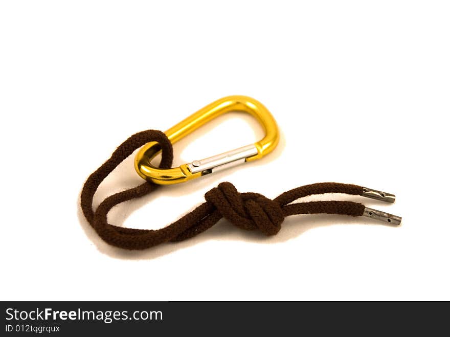 Golden carabine and brown lace isolated on the white background. Golden carabine and brown lace isolated on the white background.