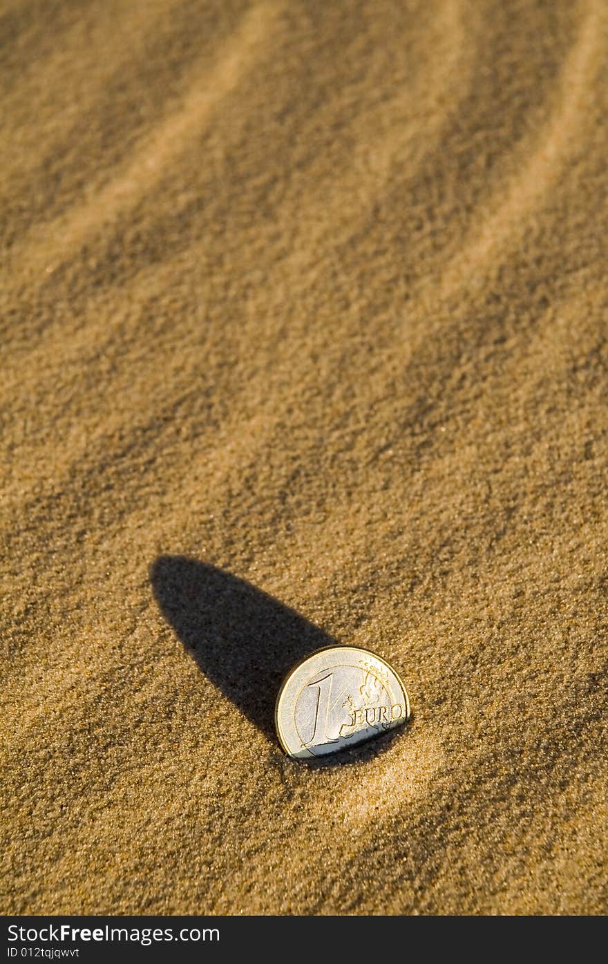 Euro Coin In The Sand