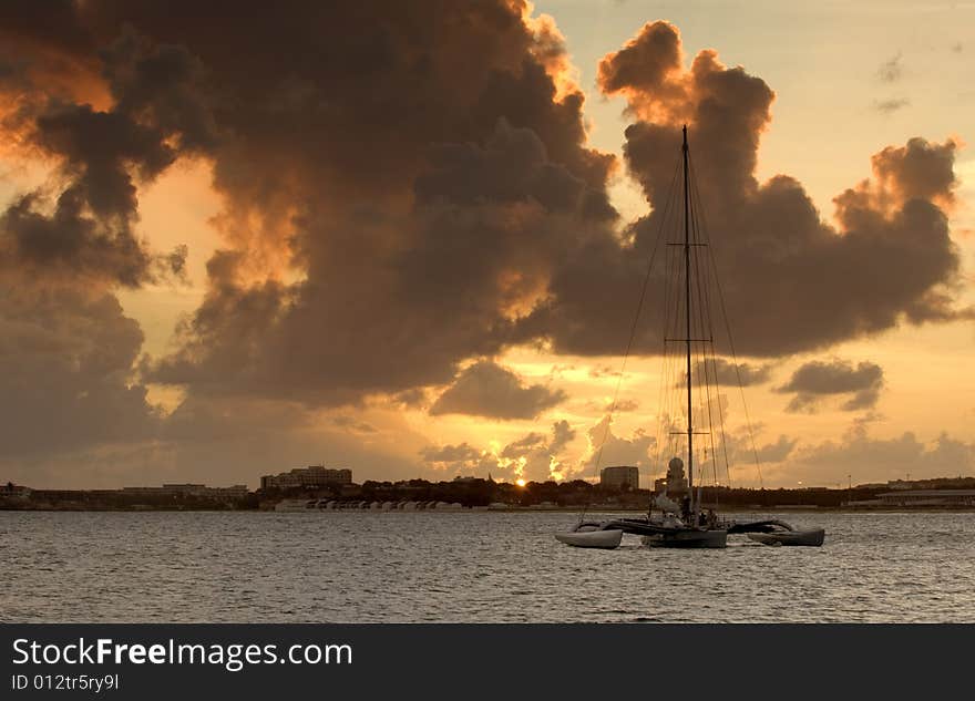 Sail boat anchored in bay at sunset. Sail boat anchored in bay at sunset