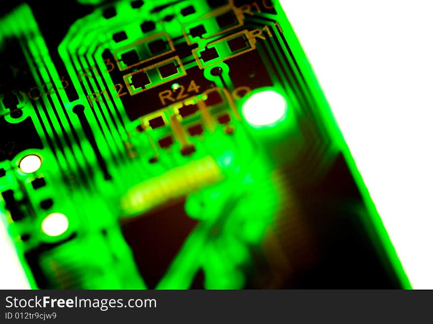 A small piece of printed circuit board over a bright lamp