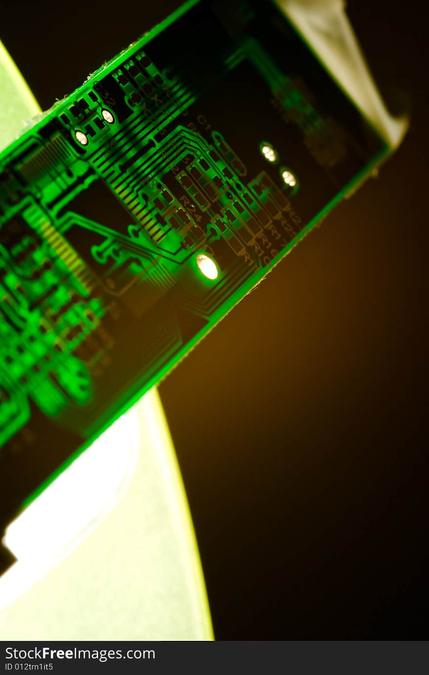 A small piece of printed circuit board over a bright lamp