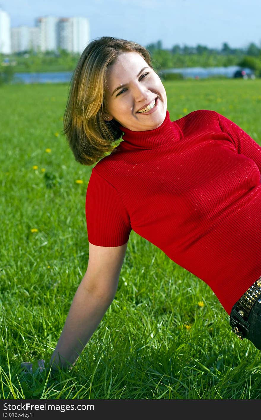 Woman in red jacket on summer's meadow. Woman in red jacket on summer's meadow.