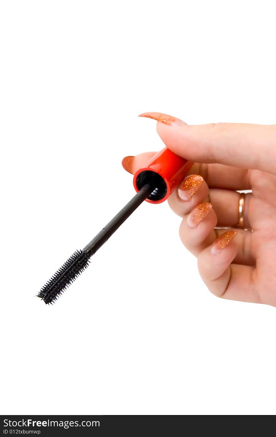 Female hand holding a mascara brush