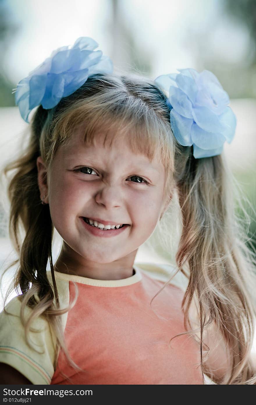 An image of smiling girl. On blurred background