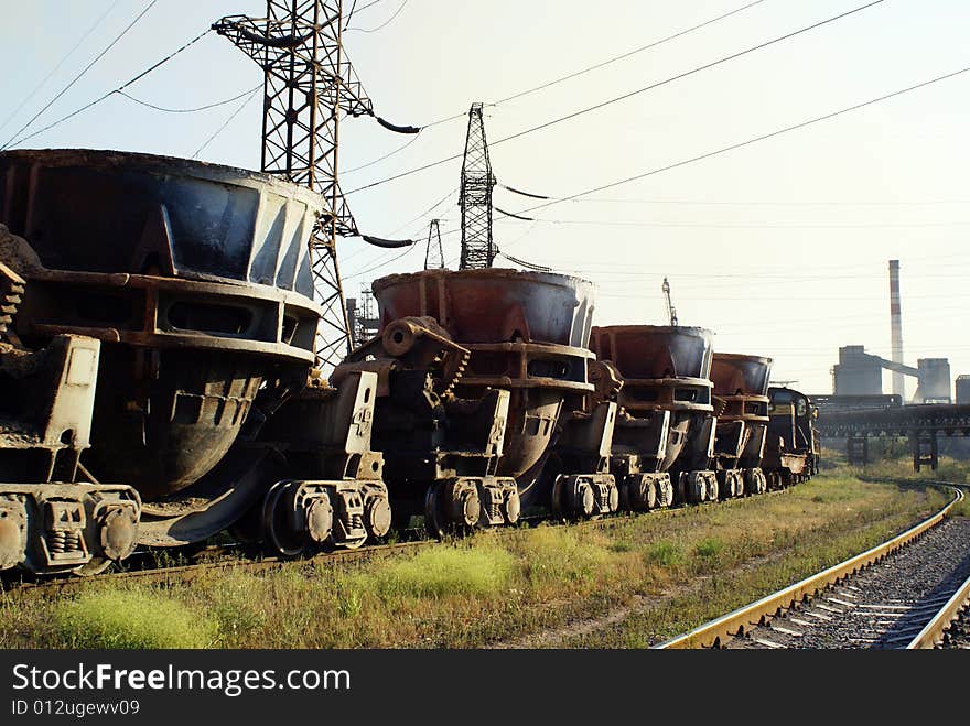 Train shunting in steelworks with smokestacks