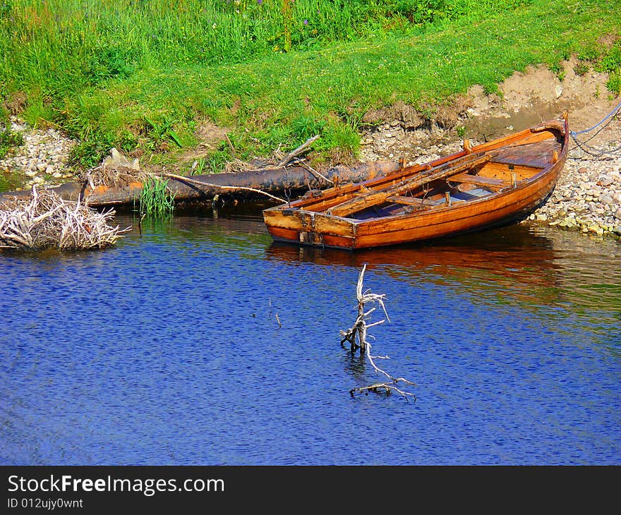 A fishing boat by the riverbank