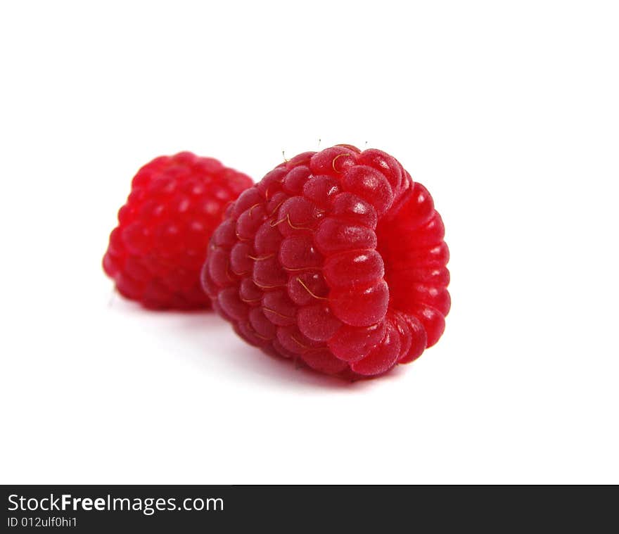 Two raspberriees isolated on white background