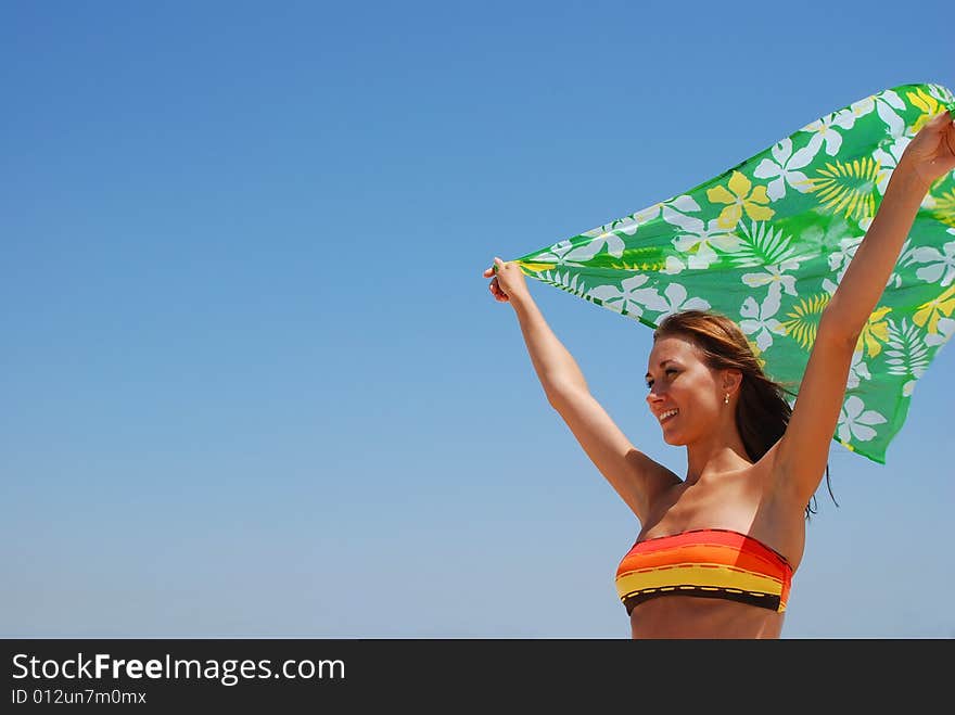 Young beautiful woman has a rest on coast of ocean. Young beautiful woman has a rest on coast of ocean