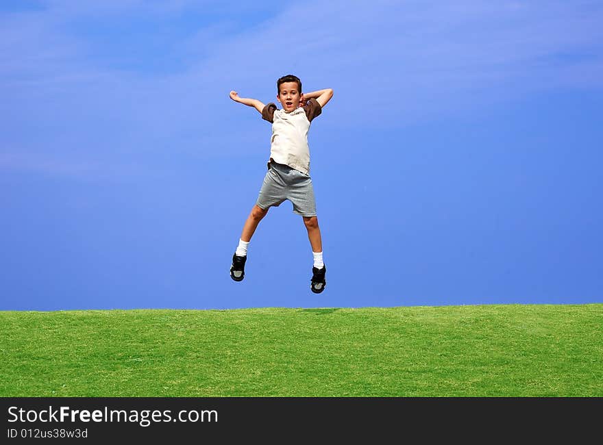 Boy jumping for joy on a clear day