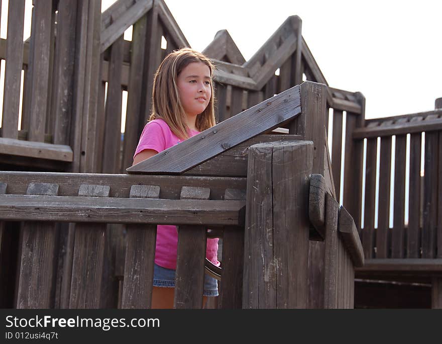 Girl playing in a playground on a sunny day. Girl playing in a playground on a sunny day