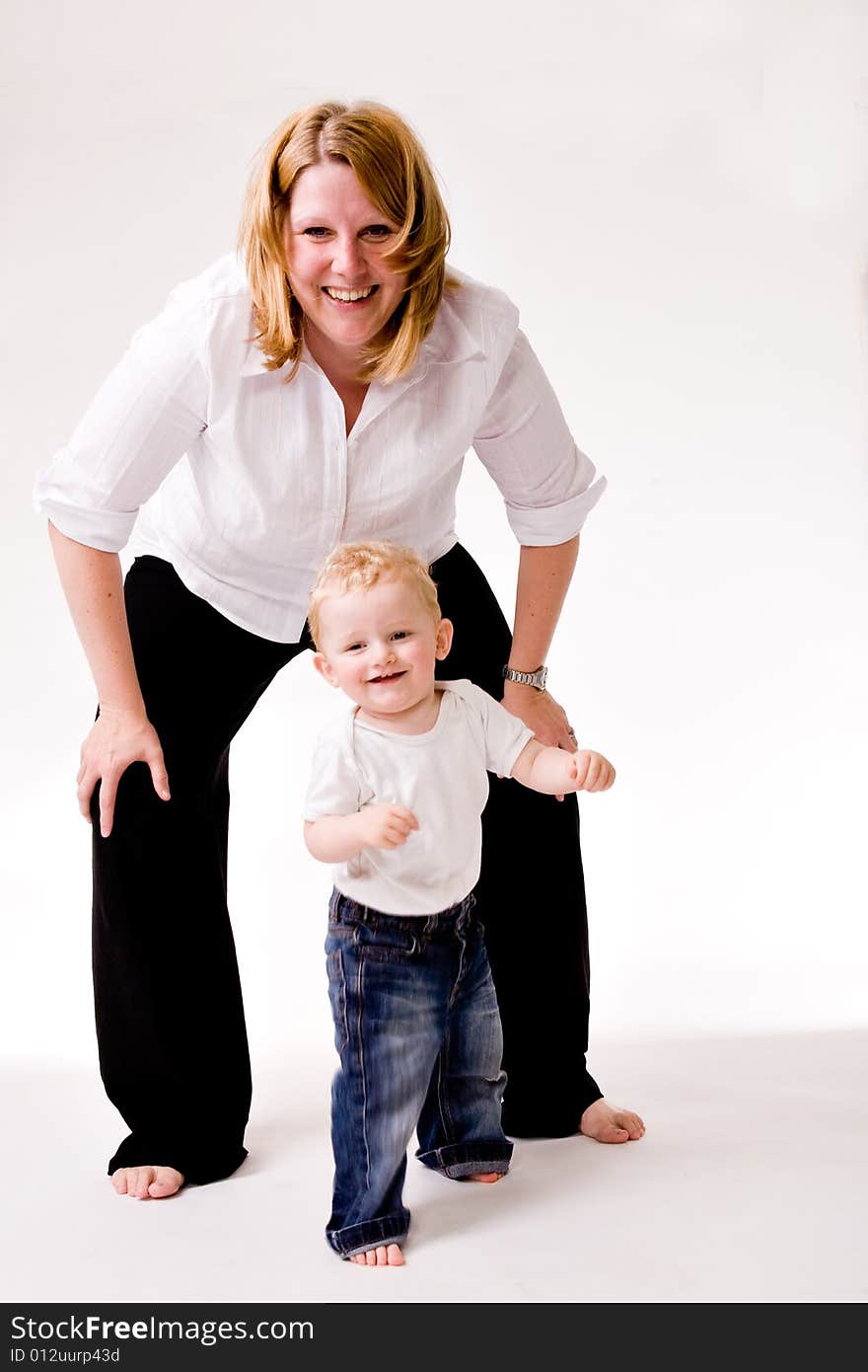 Cute Caucasian blond toddler is happy with his mother. Cute Caucasian blond toddler is happy with his mother