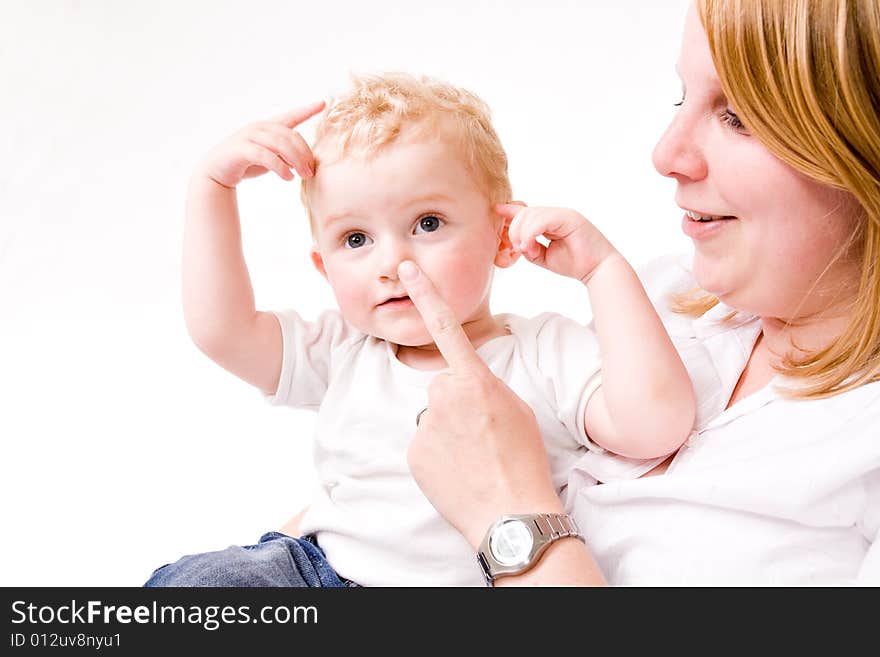 Cute Caucasian blond toddler is happy with his mother. Cute Caucasian blond toddler is happy with his mother