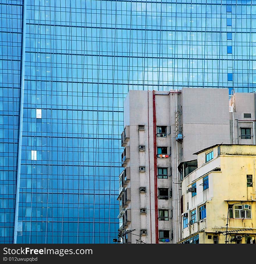 The old and worn buildings standing against the modern building. The old and worn buildings standing against the modern building.