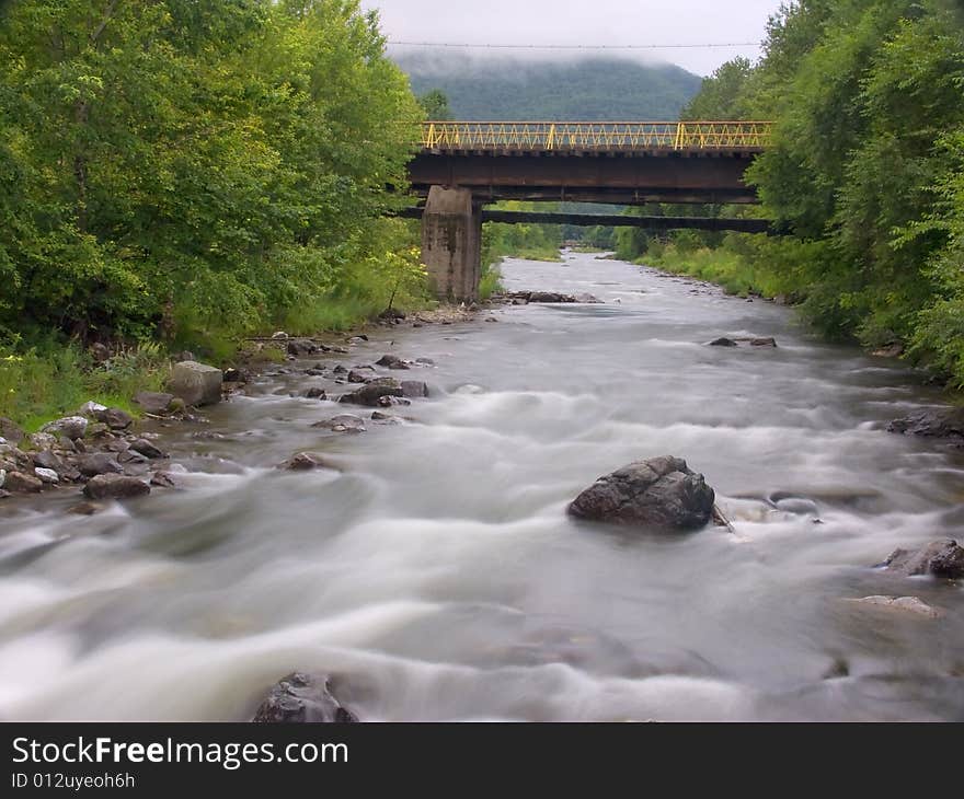 The old bridge through the river in Russia