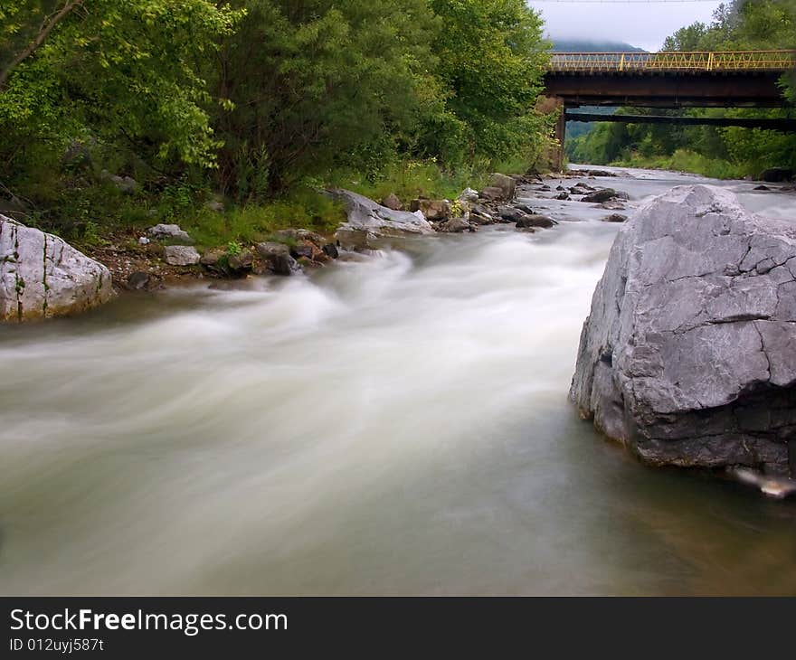 The old bridge through the river in Russia