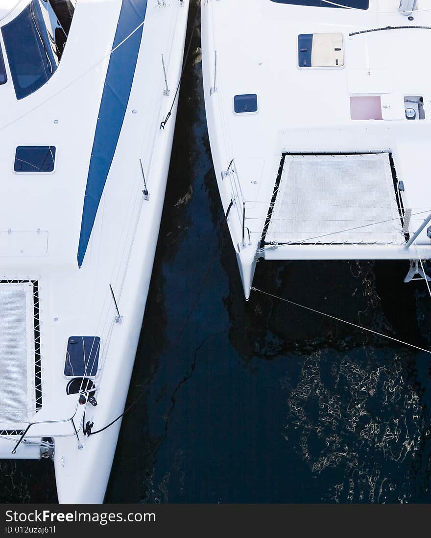 Two catamarans in a marina looking down on them