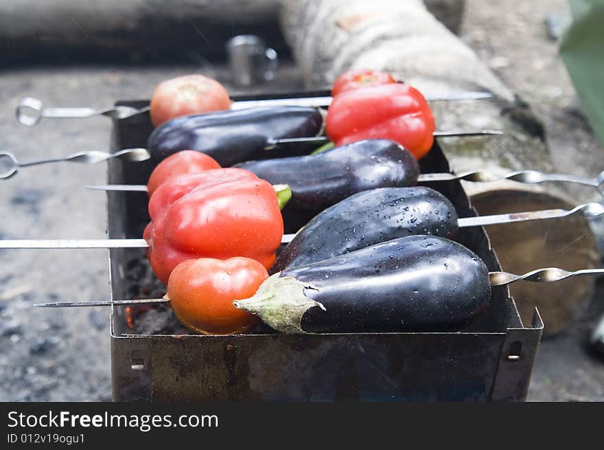 Eggplants and red bell peppers on grill