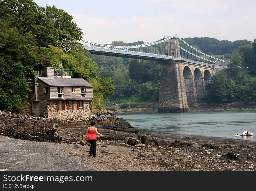 The Menai Suspension Bridge, or Pont Grog y Borth in Welsh, is a suspension bridge between the island of Anglesey and the mainland of Wales.