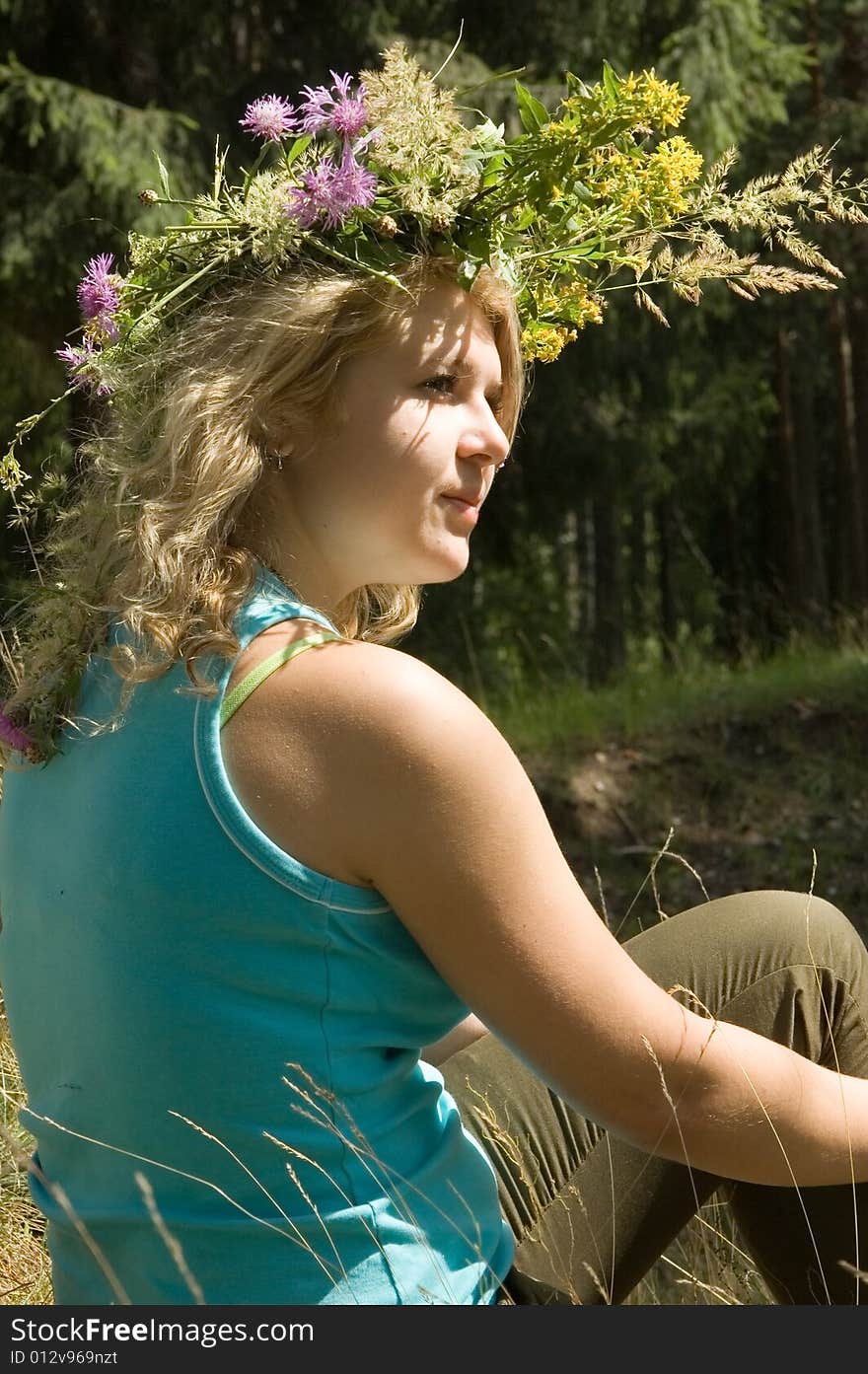 Young beautiful woman in a summer wood