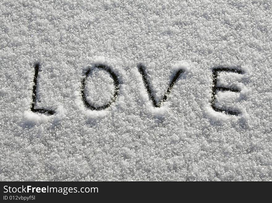 A word 'love' written on fresh snow. A word 'love' written on fresh snow