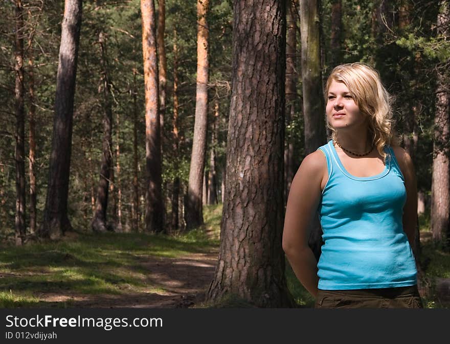 Young beautiful woman in a summer wood