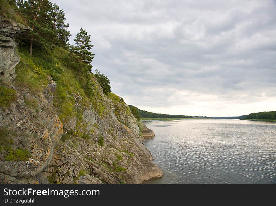 Rocky shore river in cloudy day