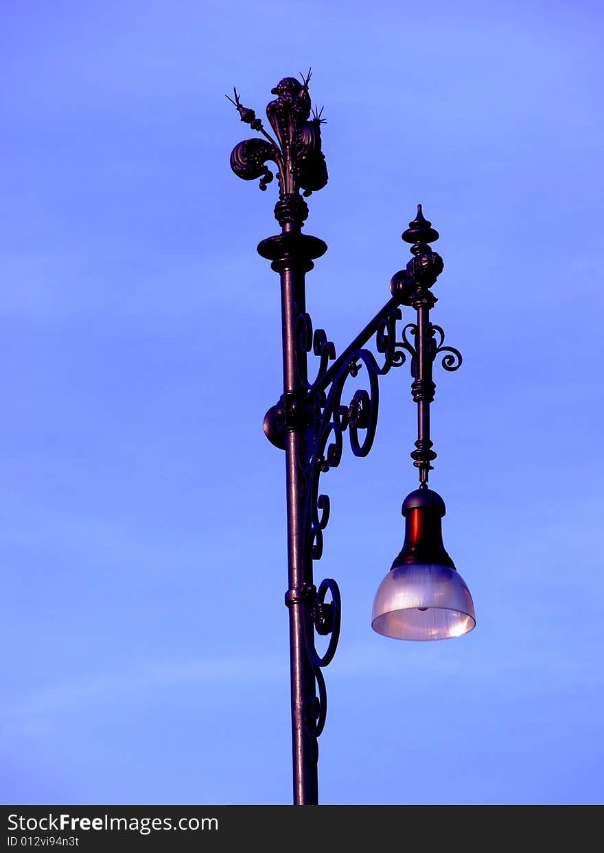 A beautiful whrought iron lamp in riverside od Arno in Florence. A beautiful whrought iron lamp in riverside od Arno in Florence