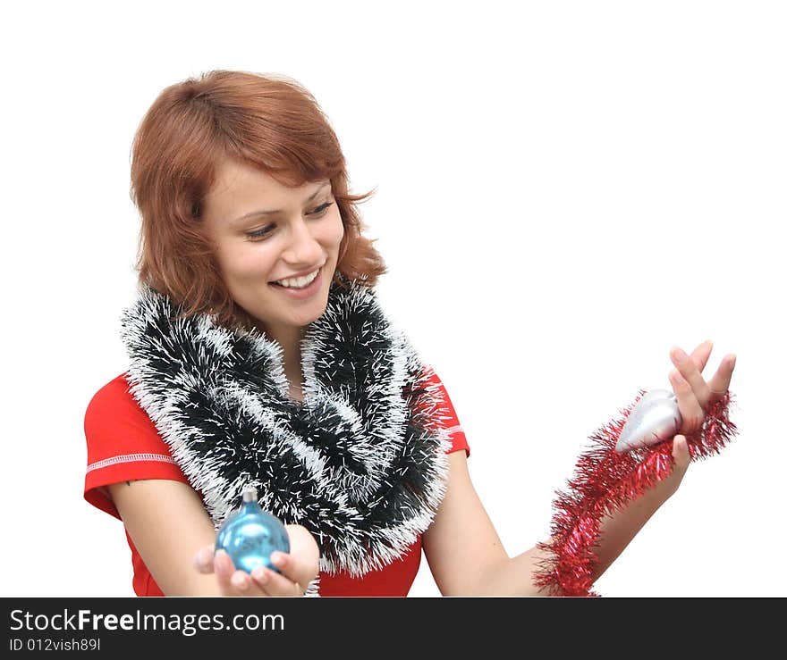 The girl in a red shirt with ornaments for the New Year tree. The girl in a red shirt with ornaments for the New Year tree.