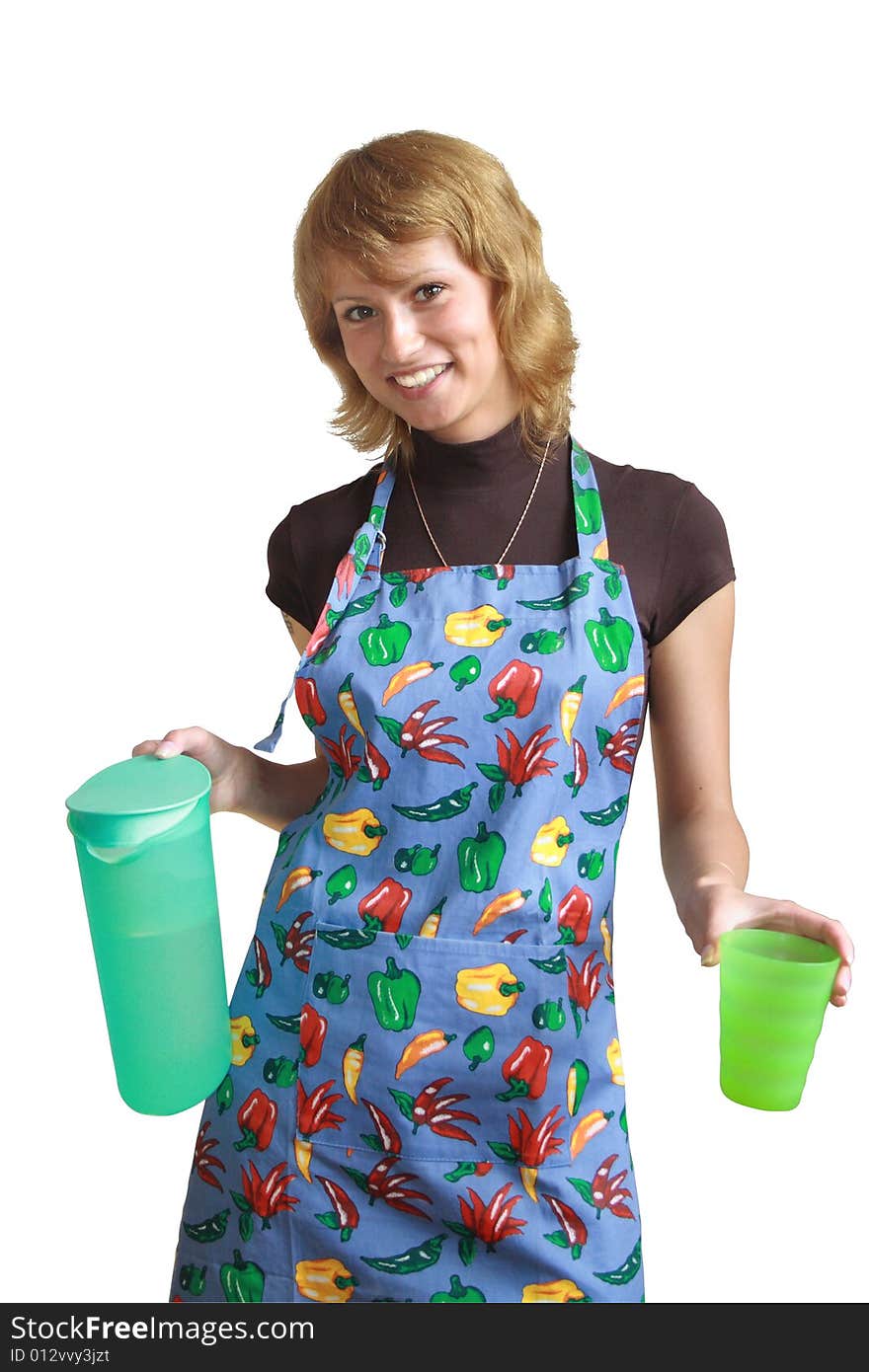 The smiling girl with a jug and a glass of green color. The smiling girl with a jug and a glass of green color.