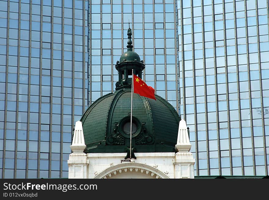 An old historic building in Dalian,east of China.proudly flying the  Chinese  flag from it's roof. An old historic building in Dalian,east of China.proudly flying the  Chinese  flag from it's roof.