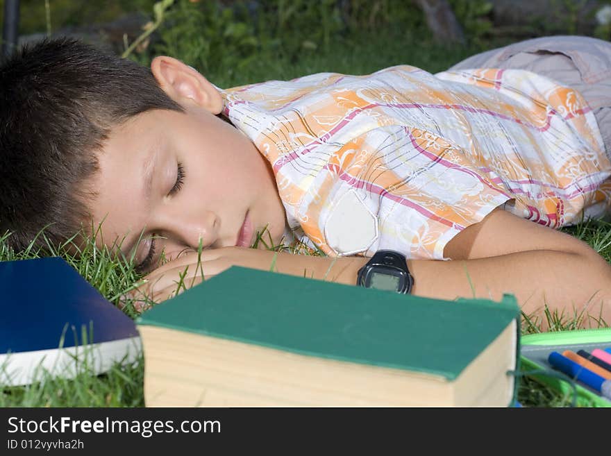 The sleeping student with books outdoors