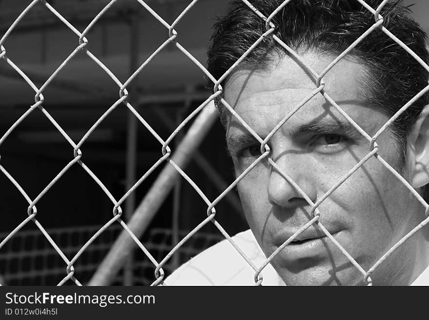 Man Behind A Fence