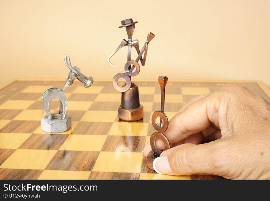 Hand holding figure on a Spanish chess board. Hand holding figure on a Spanish chess board