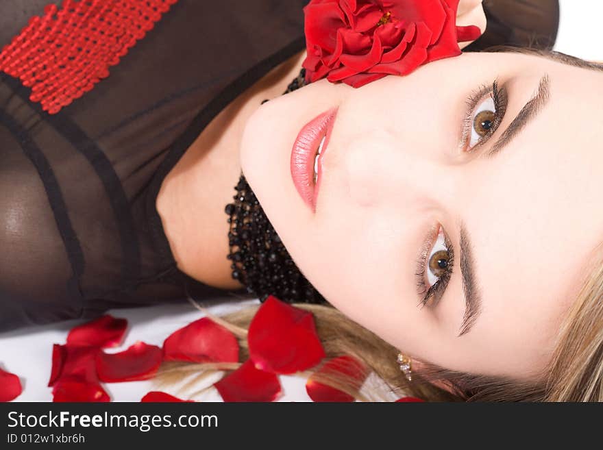 Young blond girl face (close-up portrait) in rose's petals, high key. Young blond girl face (close-up portrait) in rose's petals, high key.