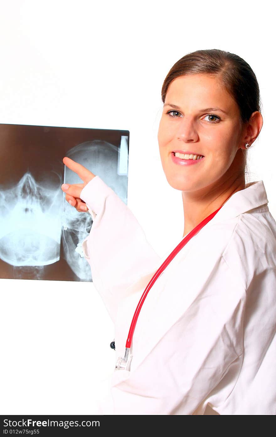 A young female doctor with a x-ray in the background and a stethoscope around the neck!. A young female doctor with a x-ray in the background and a stethoscope around the neck!