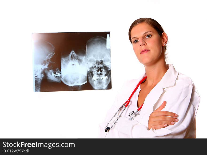 A young female doctor with a x-ray in the background and a stethoscope around the neck!. A young female doctor with a x-ray in the background and a stethoscope around the neck!