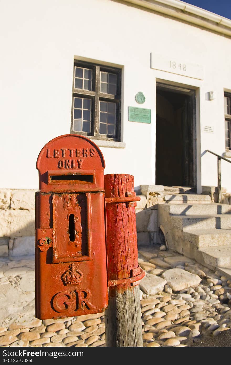 A historical mailbox at the lighthouse in Cape Aghullas, dating back to the 1800's and bearing the crest of King George V of England. Still in use. A historical mailbox at the lighthouse in Cape Aghullas, dating back to the 1800's and bearing the crest of King George V of England. Still in use.