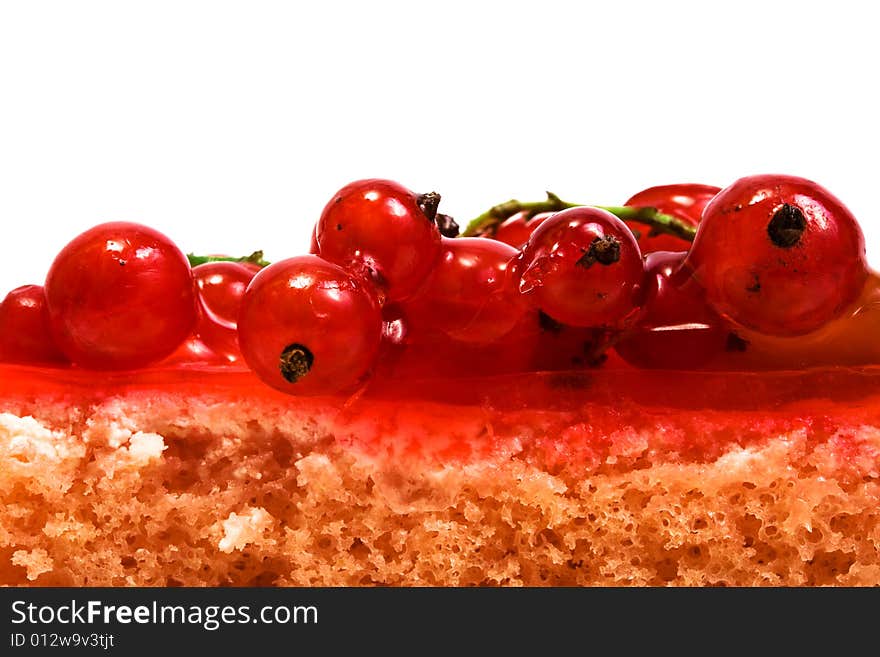 Red currant on a celebratory pie on a white background